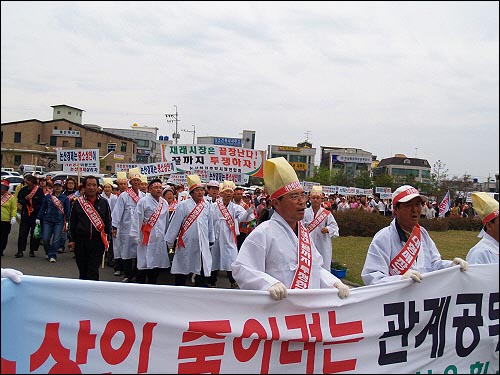 논산재래시장을 상징하는 상여를 메고 시청 안으로 들어서는 상인들 